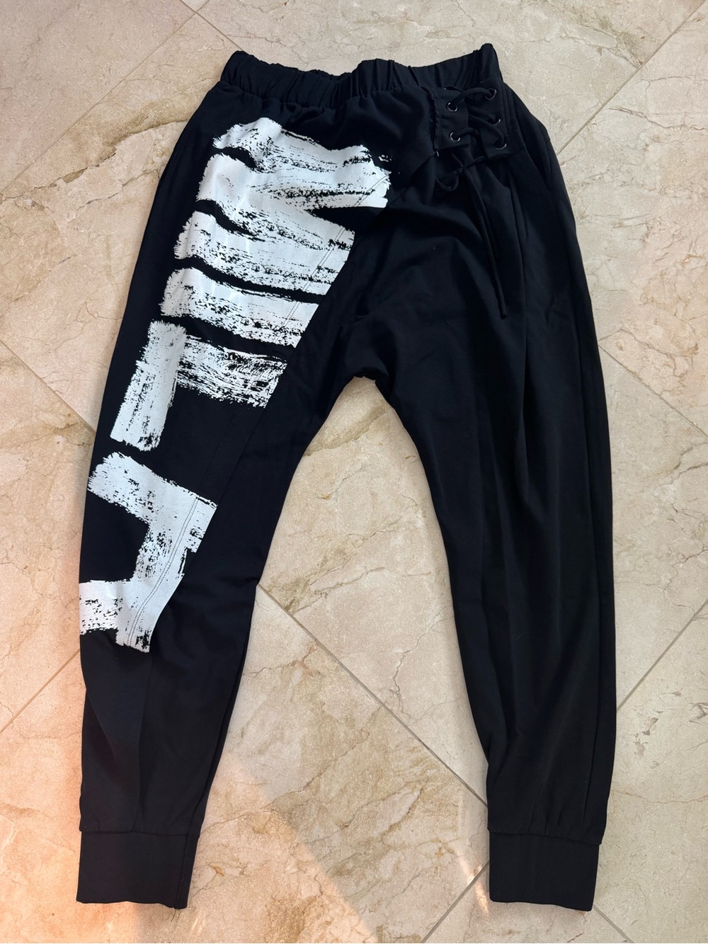 Black Jogger Pants with White Brushstroke Graphic and Asymmetrical Front